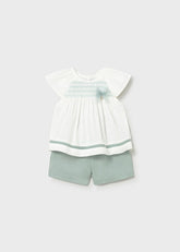 Scugnizzi 0-16 Baby Girl's white linen blend top with smocked detail and sage green shorts. Flutter sleeves.
