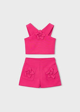 Completo estivo Scugnizzi 0-16 fucsia per bambina con top a spalline incrociate e pantaloncini con applicazioni floreali