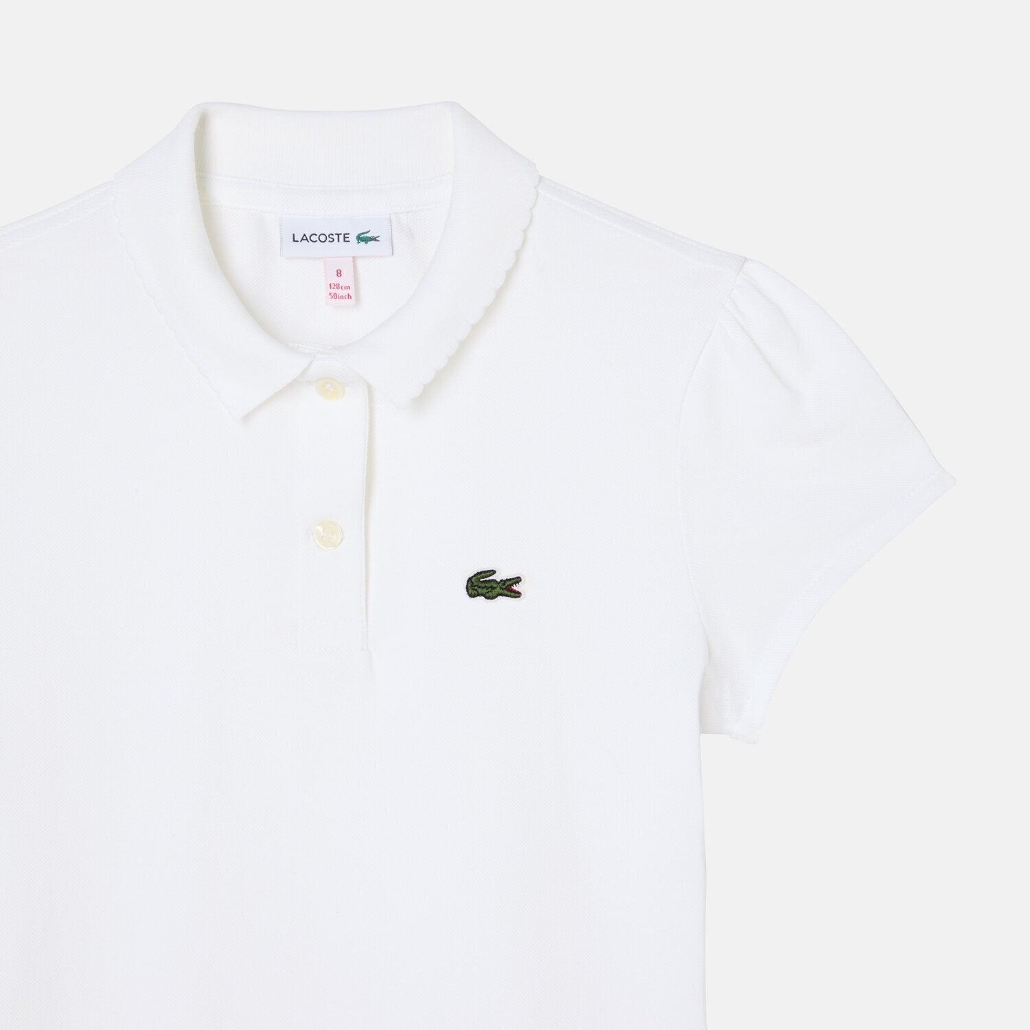 Polo bianca Lacoste per bambina in piqué di cotone con colletto smerlato, maniche arricciate e logo coccodrillo