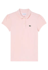 Polo Lacoste rosa per bambina in petit piqué di cotone con maniche a sbuffo, colletto smerlato e logo ricamato.