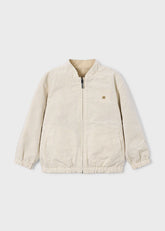 Giacca bomber reversibile Scugnizzi per bambino, un lato a fantasia pied-de-poule beige, l'altro lato color sabbia. Zip frontale e colletto alla coreana.