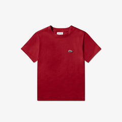 T-shirt rossa in jersey di cotone Lacoste per bambini con logo coccodrillo ricamato, proposta da Scugnizzi 0-16