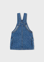 Abito salopette in denim blu per bambina Scugnizzi 0-16 con motivo a cuori all-over e tasche applicate.